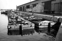 Steam tug No 574 towing compartment boats loaded with coils of wire.