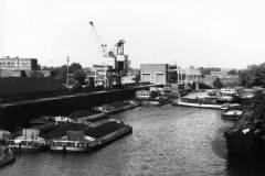 Coal-laden motor barges await unloading