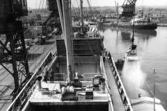 Overside discharging of a 1800-ton cargo of bulk sulphur.